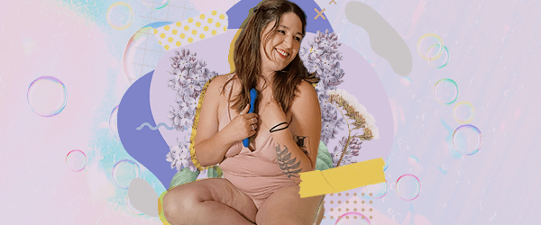 A person in a soft pink lingerie outfit smiles while holding the Sway by Lora diCarlo. They sit in front of an abstract background of lavendar and aqua, with lilac flowers behind them and pieces of yellow tape as visual accents.